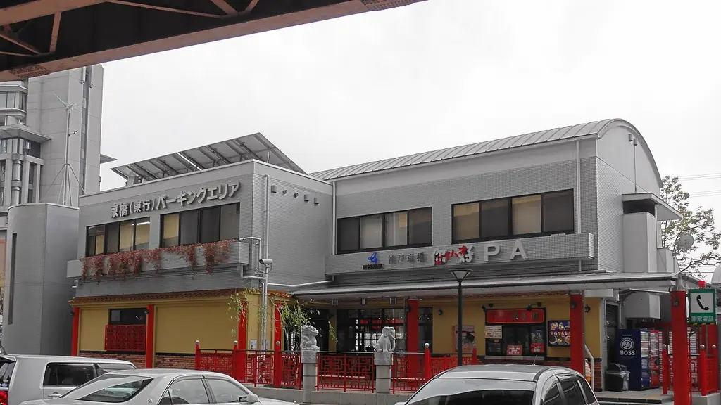 京橋パーキングエリアの、「京橋」の文字と赤い柵が付いた2階建ての建物と、手前の車の写真
