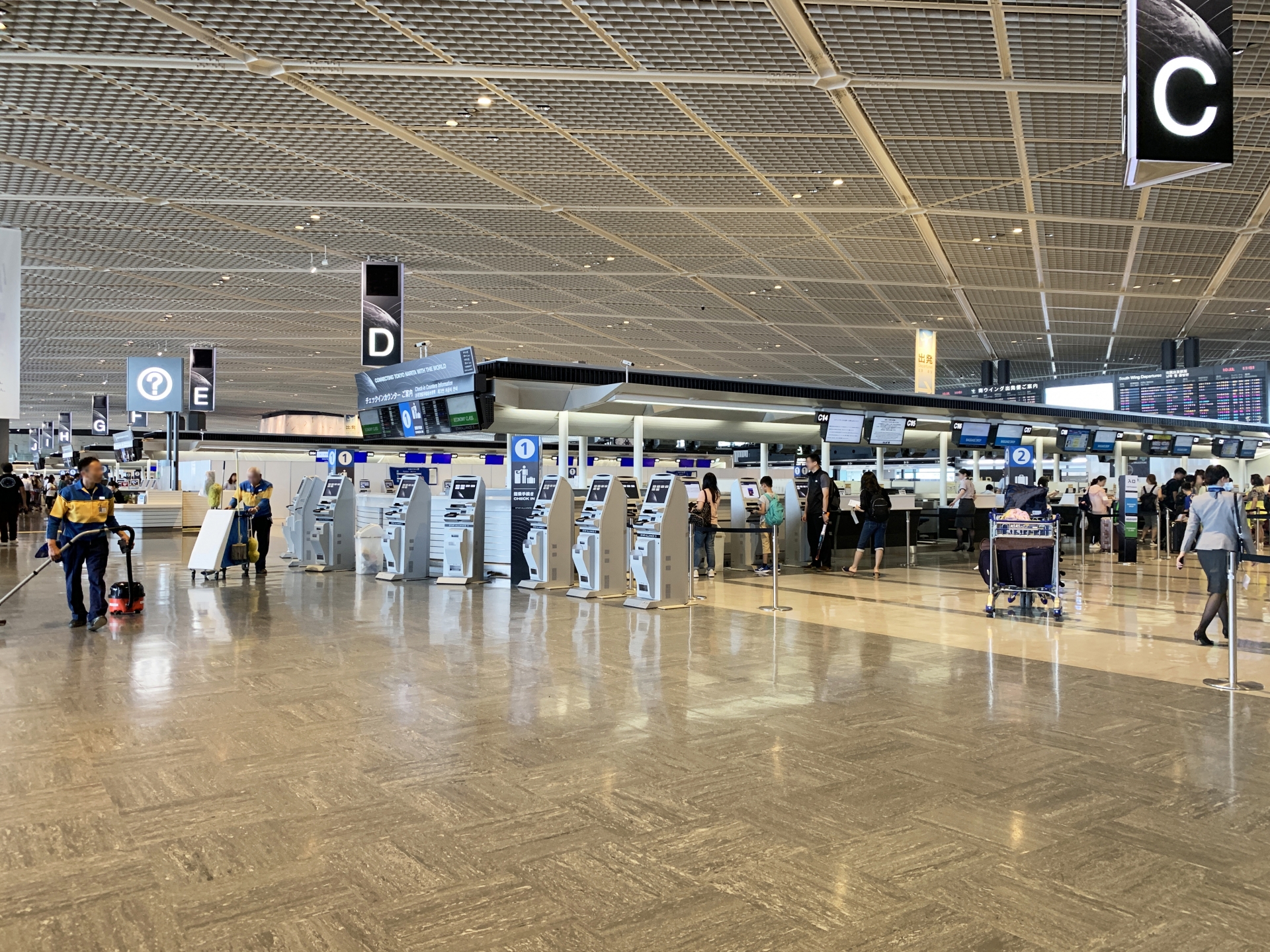 空港のチェックインカウンターが並ぶフロア
